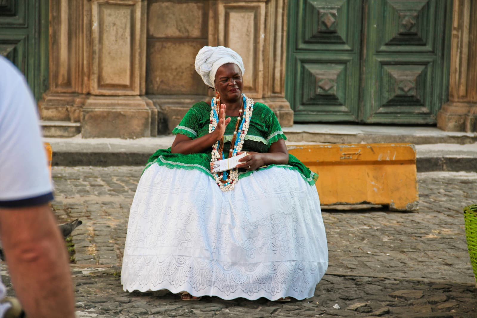 A Bahian woman in traditional dress, representing Salvador's living Afro-Brazilian culture.