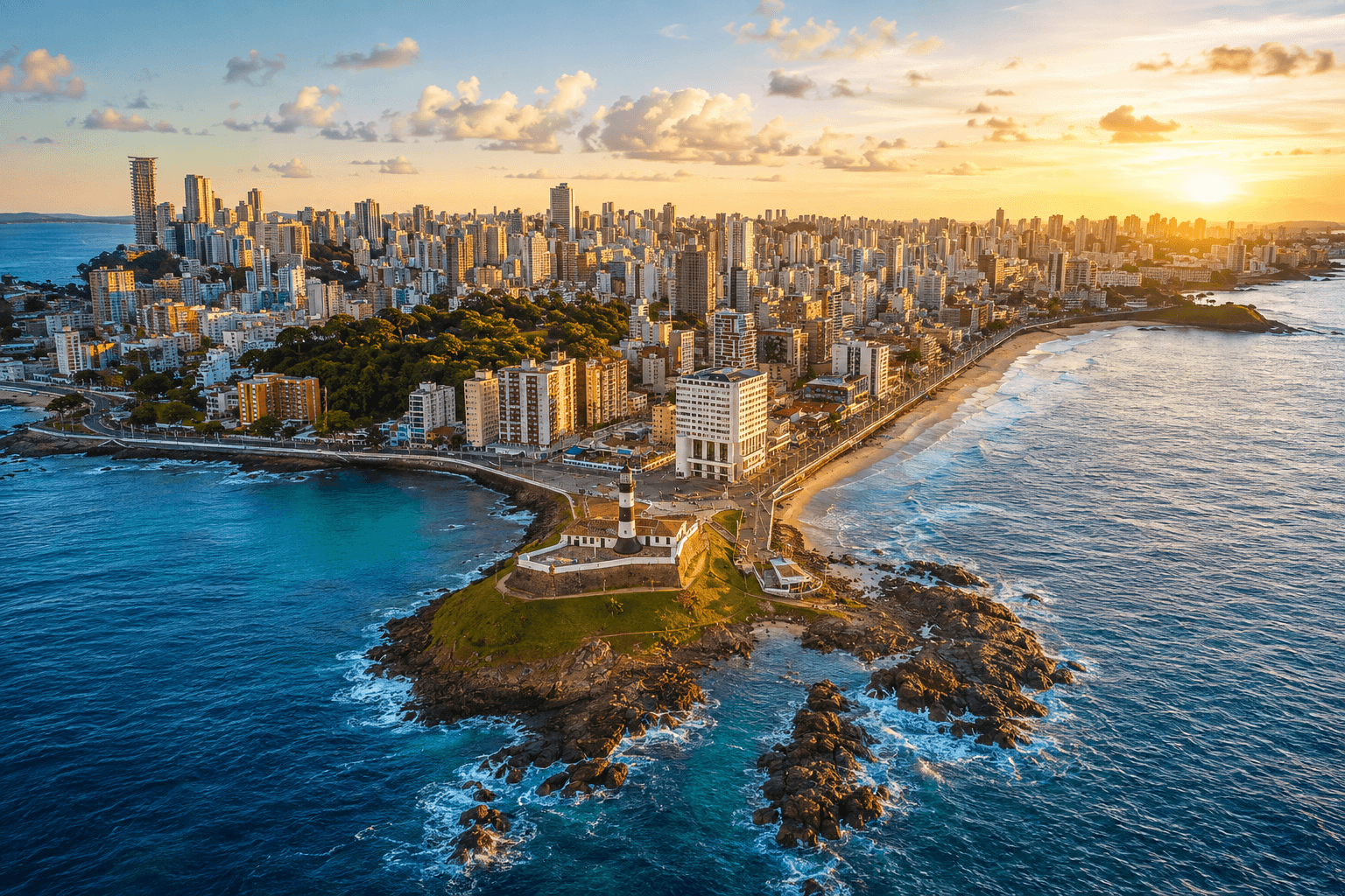 Aerial panorama of Salvador from Farol da Barra, with the lighthouse in the foreground, the Atlantic coast and the city skyline stretching inland.