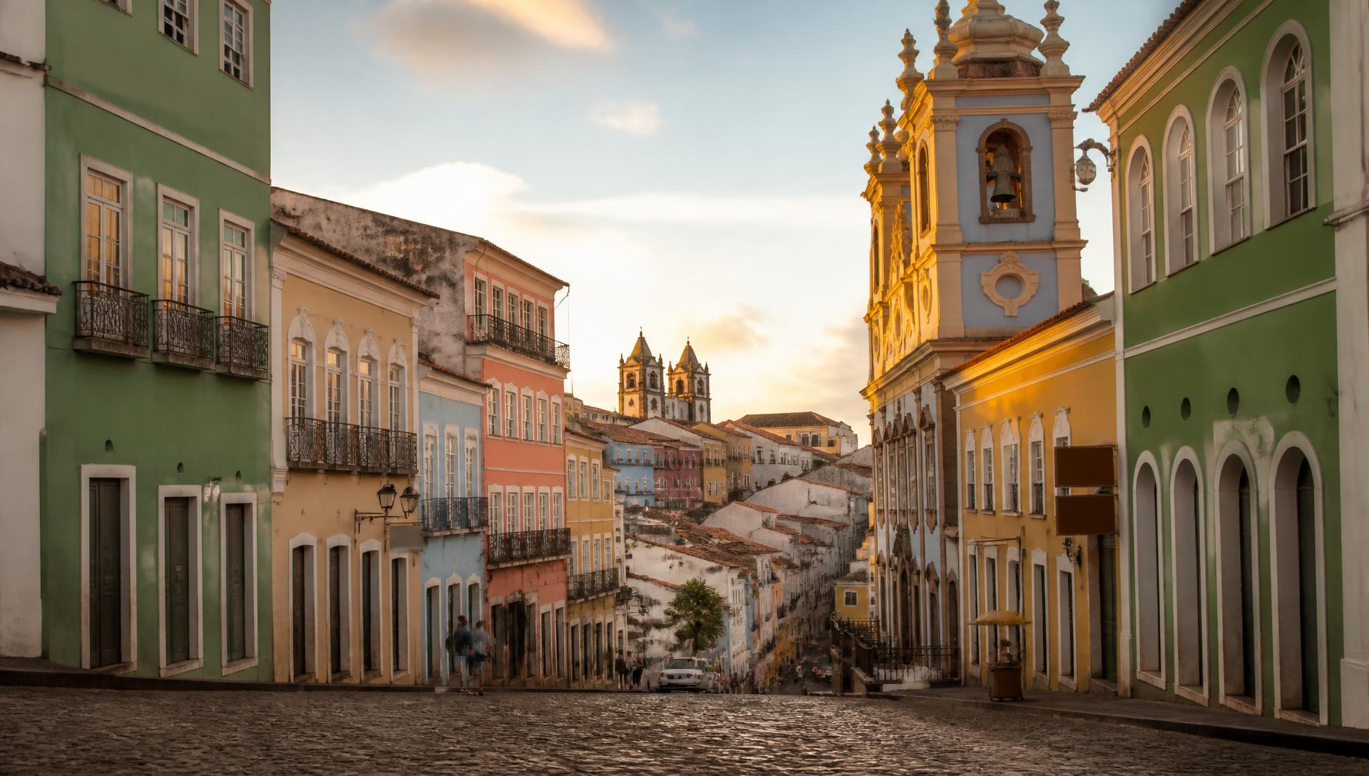 Colourful colonial facades and a baroque church tower on a cobbled street in Pelourinho, Salvador.